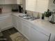 Kitchen with double sink, white cabinets, and stainless steel dishwasher at 12221 N 122 Dr, El Mirage, AZ 85335