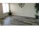 Living room with large window, laminate wood floor and potted plant at 12221 N 122 Dr, El Mirage, AZ 85335