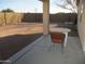 Covered patio with small table and chairs, overlooking backyard at 12221 N 122 Dr, El Mirage, AZ 85335