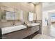 Modern bathroom with double vanity and large mirrors at 13645 E Columbine Dr, Scottsdale, AZ 85259