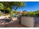 Outdoor kitchen and patio area with built-in grill, comfortable seating, and desert landscaping at 1536 W Blaylock Dr, Phoenix, AZ 85085