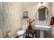 Stylish powder room with updated fixtures and decorative wallpaper at 1536 W Blaylock Dr, Phoenix, AZ 85085