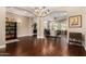 Open concept dining room with a chandelier and hardwood floors at 1536 W Blaylock Dr, Phoenix, AZ 85085