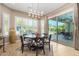 Elegant dining room with a round table, large windows, and sliding door access to patio at 1536 W Blaylock Dr, Phoenix, AZ 85085