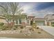 Charming single-story home showcasing desert landscaping, a two-car garage, and a brick facade, creating inviting curb appeal at 1536 W Blaylock Dr, Phoenix, AZ 85085