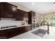 Modern kitchen with stainless steel appliances and dark wood cabinetry at 1536 W Blaylock Dr, Phoenix, AZ 85085