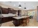 Modern kitchen with dark cabinetry, a large island, and stainless steel appliances at 1536 W Blaylock Dr, Phoenix, AZ 85085