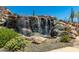 Serene waterfall feature with native desert landscaping at 1536 W Blaylock Dr, Phoenix, AZ 85085