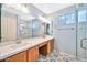 Updated bathroom with double vanity and patterned floor at 15653 W Monterey Way, Goodyear, AZ 85395