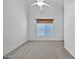 Bright bedroom featuring a window with blinds and ceiling fan at 15653 W Monterey Way, Goodyear, AZ 85395