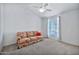 Bedroom with floral couch and window with blinds at 15653 W Monterey Way, Goodyear, AZ 85395