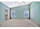 Bright bedroom with two windows, ceiling fan, and carpet flooring at 15653 W Monterey Way, Goodyear, AZ 85395