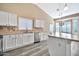 White kitchen with stainless steel appliances and island at 15653 W Monterey Way, Goodyear, AZ 85395