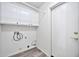 Laundry room with white cabinets and gray vinyl flooring at 15653 W Monterey Way, Goodyear, AZ 85395