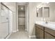 Bathroom featuring a double vanity, walk-in shower, and closet at 1587 S 239Th Dr, Buckeye, AZ 85326