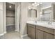 Double vanity bathroom with modern fixtures and a walk-in shower at 1587 S 239Th Dr, Buckeye, AZ 85326