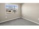 Spacious bedroom with a window showing a view of neighboring houses at 1587 S 239Th Dr, Buckeye, AZ 85326