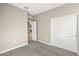 Bedroom with carpet flooring, door to another room, and double door closet at 1587 S 239Th Dr, Buckeye, AZ 85326