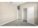 Well-lit bedroom featuring carpet, a closet, and an additional door at 1587 S 239Th Dr, Buckeye, AZ 85326