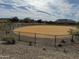 Fenced community dog park area, landscaped with desert plants and providing a safe space for pets at 1587 S 239Th Dr, Buckeye, AZ 85326