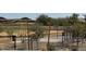 The dog park includes a fenced in area with desert plants, turf, and desert landscaping in the background at 1587 S 239Th Dr, Buckeye, AZ 85326