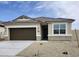 Charming single-story home featuring a two-car garage and neutral-toned stucco with brick accents at 1587 S 239Th Dr, Buckeye, AZ 85326