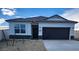 One-story house with a two-car garage and desert landscaping at 1587 S 239Th Dr, Buckeye, AZ 85326