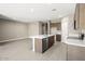 Modern kitchen with island and stainless steel appliances at 1587 S 239Th Dr, Buckeye, AZ 85326