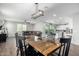 Bright dining room features a large wooden table with black chairs, and a modern light fixture at 1649 N 212Th Dr, Buckeye, AZ 85396