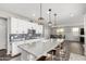 Modern kitchen with white cabinets, granite island, and stainless steel appliances at 1649 N 212Th Dr, Buckeye, AZ 85396