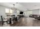 Spacious living room showcases a brown leather couch and a large flat-screen TV at 1649 N 212Th Dr, Buckeye, AZ 85396