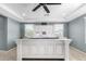 Main bedroom with large white bed frame and ceiling fan at 1649 N 212Th Dr, Buckeye, AZ 85396