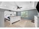 Main bedroom with large bed, ceiling fan, and plenty of natural light at 1649 N 212Th Dr, Buckeye, AZ 85396