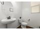 Clean powder room with pedestal sink and toilet at 1649 N 212Th Dr, Buckeye, AZ 85396