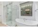 Elegant bathroom featuring a soaking tub and a frameless shower at 16611 S 9Th St, Phoenix, AZ 85048