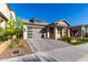 Modern home with gray garage door and paver driveway, inviting landscaping at 16611 S 9Th St, Phoenix, AZ 85048