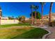 Landscaped backyard with patio, string lights, and lush lawn at 16831 S 14Th Ln, Phoenix, AZ 85045