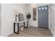 Bright entryway with gray door, console table, and mirror at 16831 S 14Th Ln, Phoenix, AZ 85045