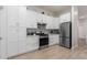 White shaker cabinets, hex tile backsplash, and stainless steel appliances at 16831 S 14Th Ln, Phoenix, AZ 85045