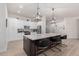 Modern kitchen with white cabinets, marble countertops, and stainless steel appliances at 16831 S 14Th Ln, Phoenix, AZ 85045