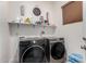 Laundry room with washer, dryer, and shelving for storage at 16831 S 14Th Ln, Phoenix, AZ 85045