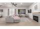 Spacious living room with gray sectional sofa and modern fireplace at 16831 S 14Th Ln, Phoenix, AZ 85045