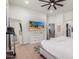 Main bedroom with large TV, bright lighting and a walk-in closet at 16831 S 14Th Ln, Phoenix, AZ 85045