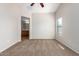 Bedroom with ceiling fan, carpet, and ensuite bathroom at 1749 W Desert Mountain Dr, San Tan Valley, AZ 85144