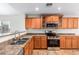 Kitchen features stainless steel appliances and oak cabinets at 1749 W Desert Mountain Dr, San Tan Valley, AZ 85144