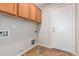 Laundry room with wood cabinets and tile flooring at 1749 W Desert Mountain Dr, San Tan Valley, AZ 85144