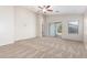 Living room featuring neutral carpeting and sliding glass doors at 1749 W Desert Mountain Dr, San Tan Valley, AZ 85144