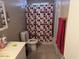 Bathroom with sink, toilet, tub, and patterned shower curtain at 17862 N 31St Ave, Phoenix, AZ 85053