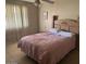 Bedroom with a bed, a window, and tiled floors at 17862 N 31St Ave, Phoenix, AZ 85053