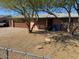 Well-kept single-story home with driveway, an attached garage, and trees in the front yard at 17862 N 31St Ave, Phoenix, AZ 85053